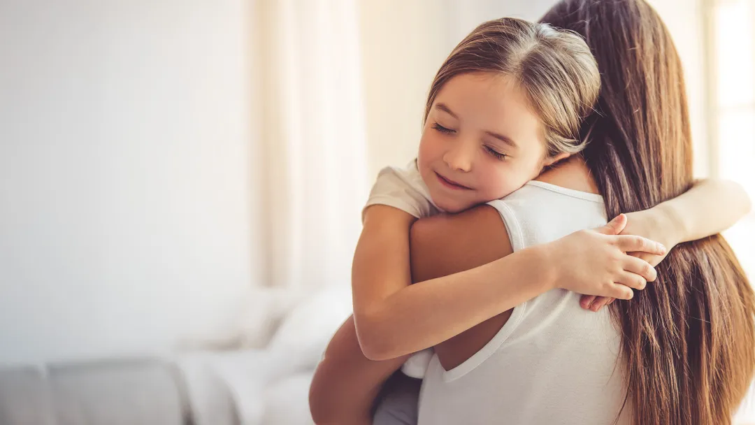Young child embracing her mother