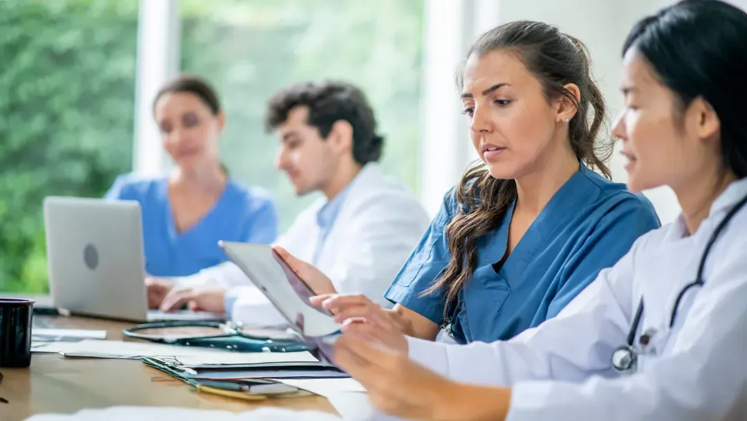A Resident Speaks with Another Doctor About a Document.