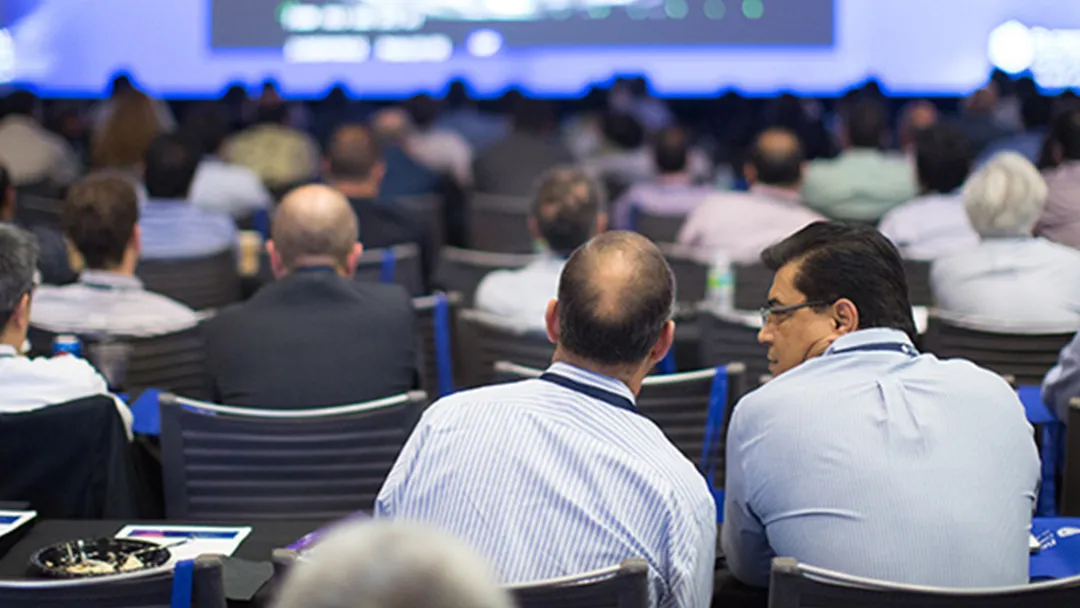 Audience watching presentation in Nicholson Center Education Center room.