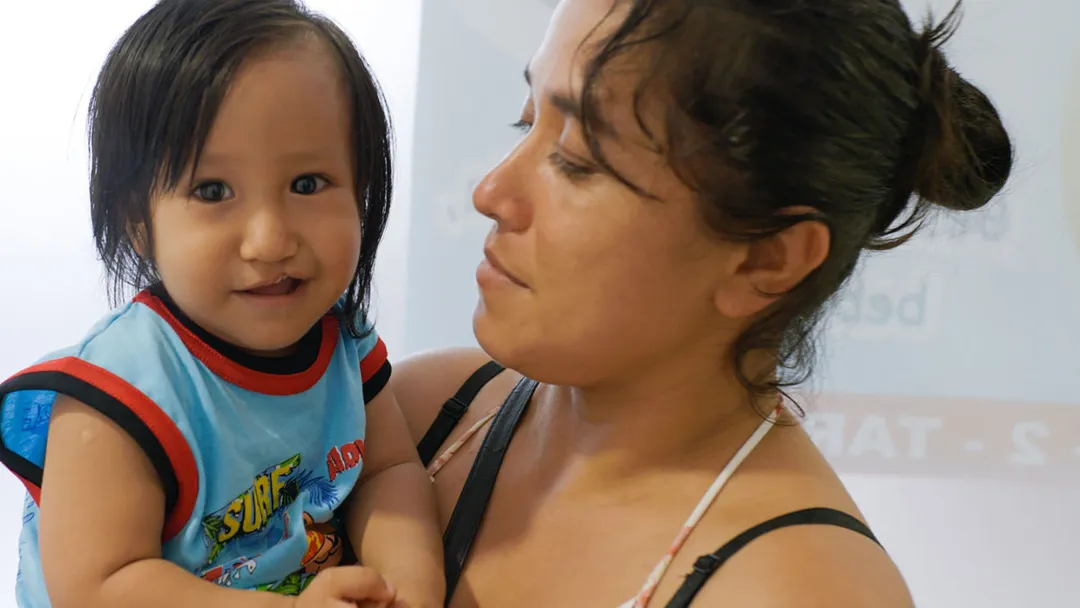 a child being held by a woman