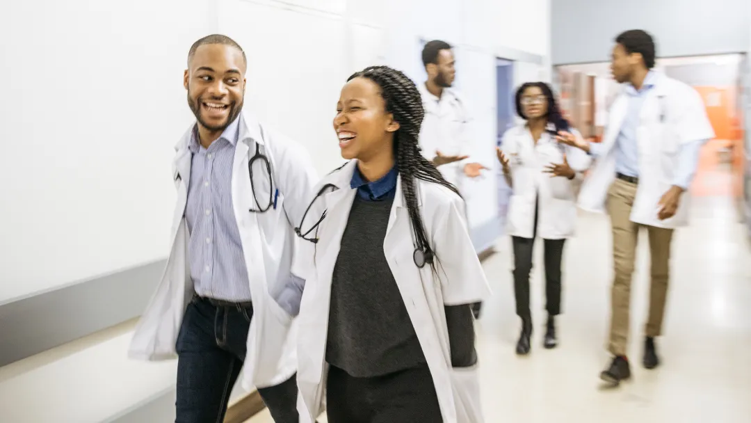 Medical students walking down a hallway.