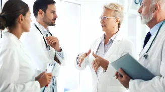 Physician's speaking with residents.