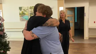 Gary Giovia hugging care team member