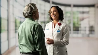 A female doctor speaking with a man