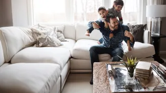 father playing with his two sons indoors