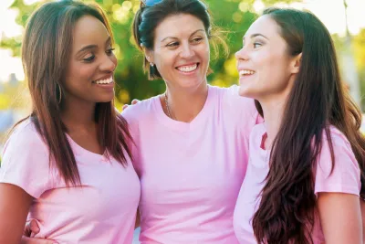 Three women in pink shirts