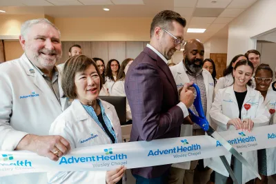 Group of people at the ribbon cutting of Wesley Chapel.