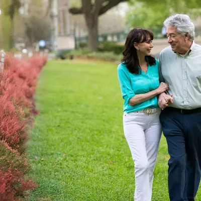 a mature couple walking outdoors