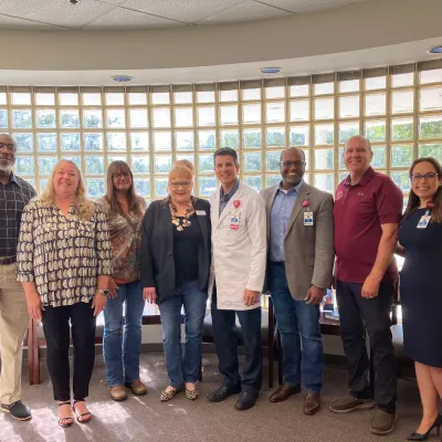 Clinic patients Teresa Leford and Rena Weldon visits with physicians, hospital leaders and State Representative Truenow.