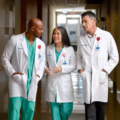 Three providers walking and talking together. 