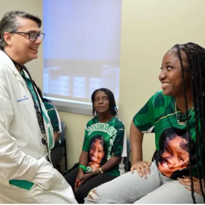 Jermila Pompey, and her family, with Dr. Michael Angelis, at AdventHealth Transplant Institute.