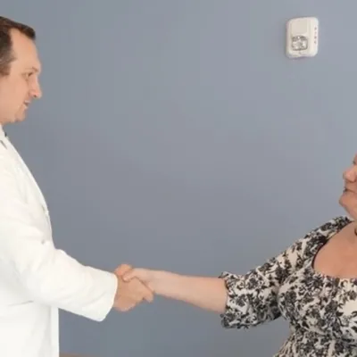 Dr. A.J. Clair talks to patient, Jean McMichael, during an office visit at Rothman Orthopaedics at AdventHealth Innovation Tower