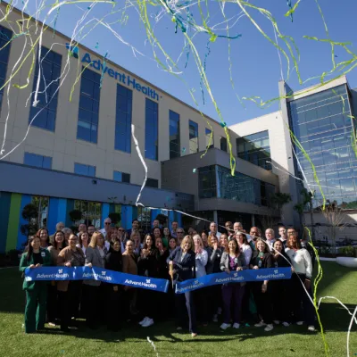 Team members cut the ribbon to officially open AdventHealth Minneola.