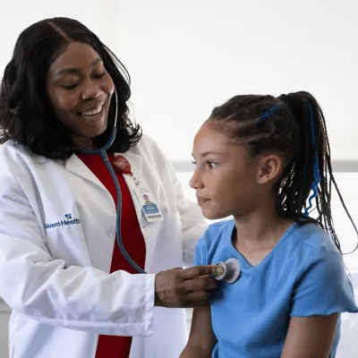 A Physician Checks Her Child Patient's Breathing with a Stethoscope 