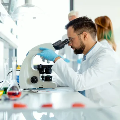 Scientist looking in microscope