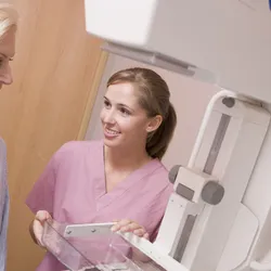 Mammogram technician with patient.