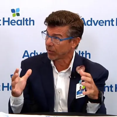 Dr. Schoch seated and speaking