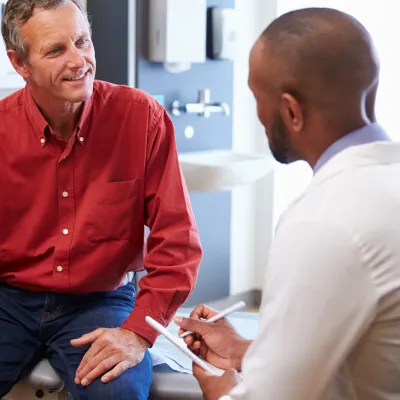 A man discusses his health with his doctor.