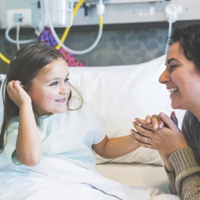 Mom With Young Girl in Hospital Bed