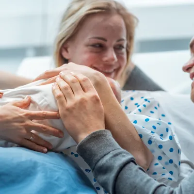 A happy family celebrates their new baby.