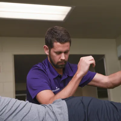 AdventHealth Physical Therapist working on a Solar Bears team member.