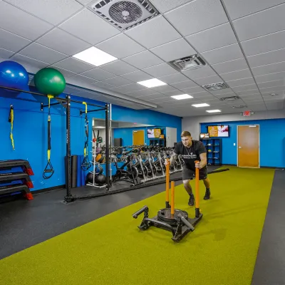 A man working out in the AdventHealth Wellness Center training room