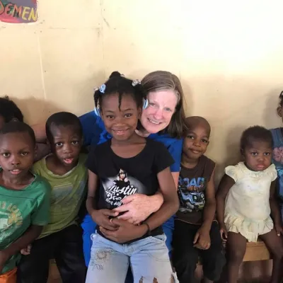 Mission worker with Haitian children