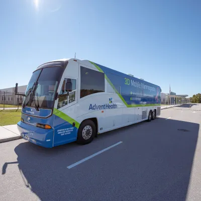 An AdventHealth bus on the road