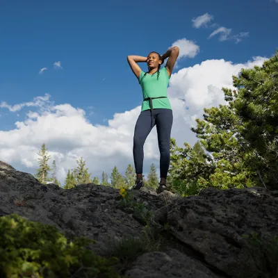 Woman on top of cliff.