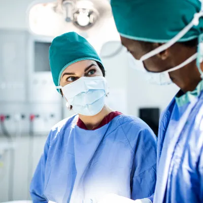 Masked Physicians talking in operating room
