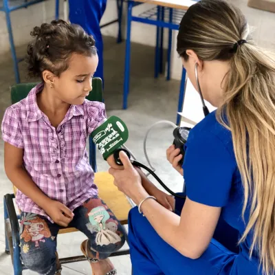 A nurse checking the blood pressure of a girl