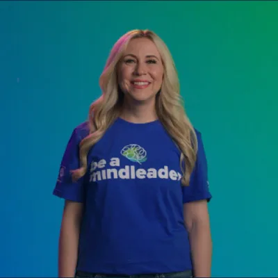 A woman wearing a shirt that says "Be a Mindleader"