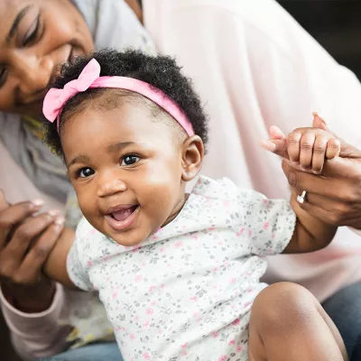 Teaching her little girl to stand.