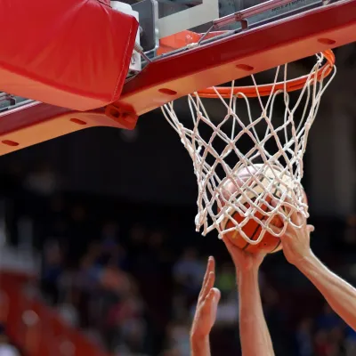 A basketball player dunking a ball.
