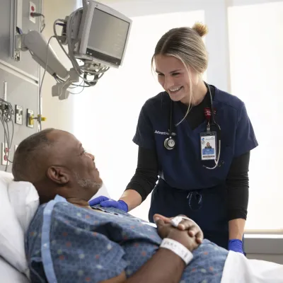 Nurse smiling at patient.