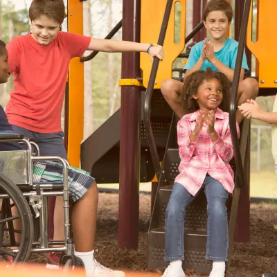 A group of kids talking at the playground