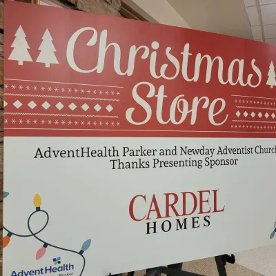 Sign welcoming families to the Christmas Store