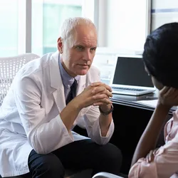 Patient contemplating with doctor about surgery