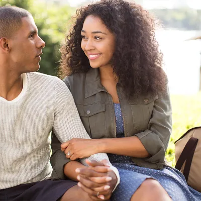 Couple holding hands by the lake