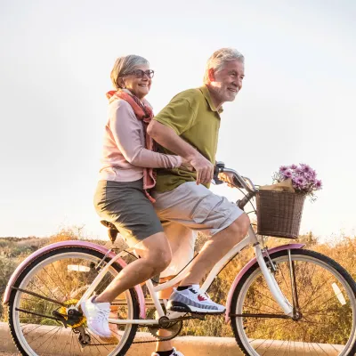 Older couple riding a bike together.