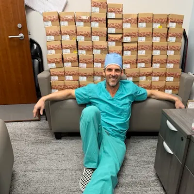 Dr. Jayson Sack and a stack of shoes