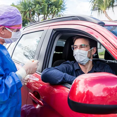 person receiving drive thru testing in a car