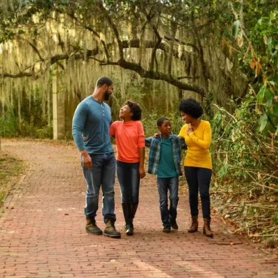 A family walks through the trees