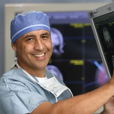 Surgeon smiling in scrubs