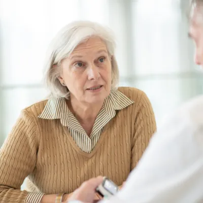 senior woman speaking with doctor