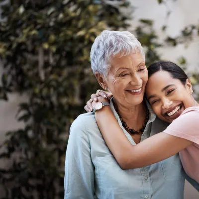 M teenage girl hugs her grandmother