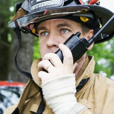 Fire Fighter Speaks on a Walkie Talkie