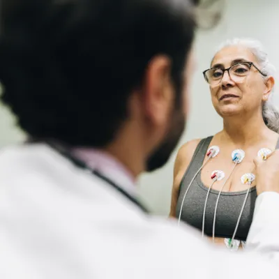 Patient talking with her doctor during a cardiopulmonary stress test on a hospital - stock photo