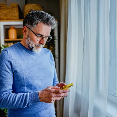 Man looking down at phone