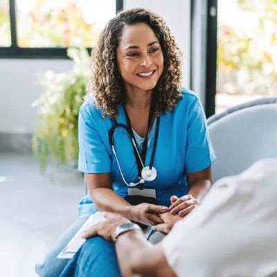 Healthcare professional talking to patient at home